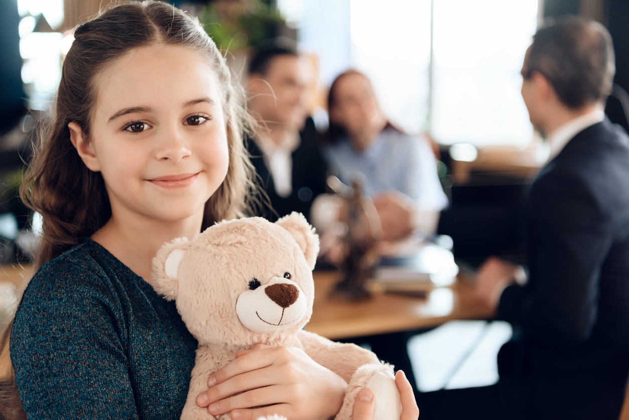 Child with teddy bear, representing adoption support by Lafayette attorneys