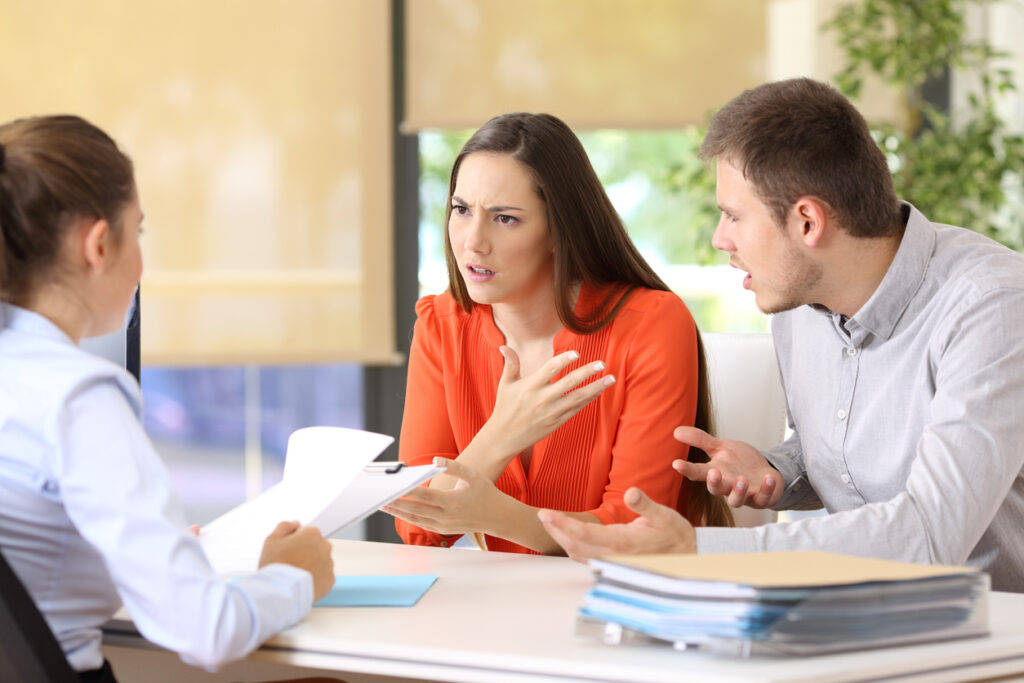 Couple discussing divorce with attorney in Lafayette law office